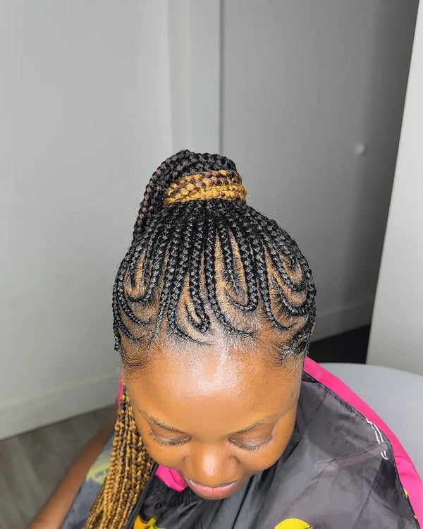 Curved feed-in cornrows swept up into a high ponytail, braided at Lovely Hair in West Des Moines