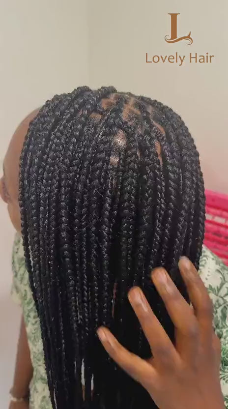 Video: a client runs her hand down her long knotless braids, braided at Lovely Hair in West Des Moines