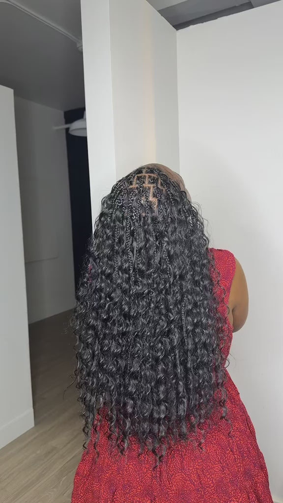 Video: the back of waist-length boho braids with curls left out, braided at Lovely Hair in West Des Moines
