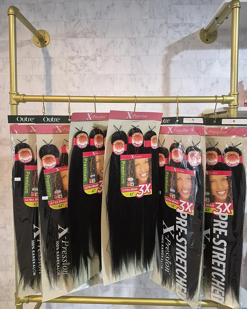 Pre-stretched braiding hair packs on the gold rack at the Lovely Hair beauty supply in West Des Moines